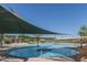 Resort-style pool with shade structures and ample seating at 8047 W Cinder Brook Way, Florence, AZ 85132