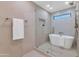 Spa-like bathroom with a soaking tub, glass shower, and elegant tile work at 8165 E Del Cuarzo Dr, Scottsdale, AZ 85258