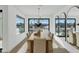 Bright dining room features a wood table, modern chandelier, and large windows with water views at 8165 E Del Cuarzo Dr, Scottsdale, AZ 85258