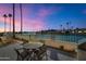 Evening view of lakefront patio with seating at 8165 E Del Cuarzo Dr, Scottsdale, AZ 85258