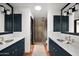 Double vanity bathroom with dark cabinetry and walk-in shower at 8255 E Vista De Valle --, Scottsdale, AZ 85255