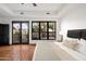 Main bedroom with access to a private patio and terracotta tile floors at 8255 E Vista De Valle --, Scottsdale, AZ 85255