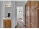 Hallway with built-in wooden cabinets and bathroom access at 8392 W Oraibi Dr, Peoria, AZ 85382