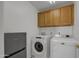 Laundry room with washer, dryer, and cabinets at 8392 W Oraibi Dr, Peoria, AZ 85382