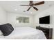 Bedroom with TV, dresser, and ceiling fan at 8631 E Jackrabbit Rd, Scottsdale, AZ 85250