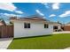 White brick home with a two car garage and lush green lawn at 8631 E Jackrabbit Rd, Scottsdale, AZ 85250