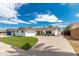 Single story home with a landscaped front yard and a two-car garage at 8631 E Jackrabbit Rd, Scottsdale, AZ 85250