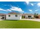 White brick home with a two car garage and lush green lawn at 8631 E Jackrabbit Rd, Scottsdale, AZ 85250