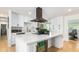 Modern kitchen with white cabinets and a built-in beverage fridge at 8631 E Jackrabbit Rd, Scottsdale, AZ 85250