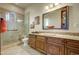 Bathroom with granite countertop, wooden cabinets, and shower at 8787 E Lost Gold Cir, Gold Canyon, AZ 85118