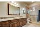 Bathroom with granite countertop, wooden cabinets, and shower at 8787 E Lost Gold Cir, Gold Canyon, AZ 85118