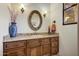 Bathroom with granite countertop, wooden cabinets, and oval mirror at 8787 E Lost Gold Cir, Gold Canyon, AZ 85118