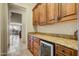 Butlers pantry with wine cooler and granite countertops at 8787 E Lost Gold Cir, Gold Canyon, AZ 85118