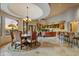 Elegant dining area with large table and chandelier, overlooking backyard at 8787 E Lost Gold Cir, Gold Canyon, AZ 85118