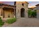 Inviting entryway with a stone arch and charming landscaping at 8787 E Lost Gold Cir, Gold Canyon, AZ 85118