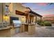 High-end outdoor kitchen with built-in grill and sink at 8787 E Lost Gold Cir, Gold Canyon, AZ 85118