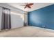 Bedroom with ceiling fan and blue accent wall at 902 W Glendale Ave # 203, Phoenix, AZ 85021