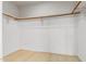 Spacious walk-in closet with wood shelving and light wood flooring at 902 W Glendale Ave # 203, Phoenix, AZ 85021