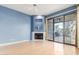 Bright living room with fireplace, hardwood floors, and sliding doors to patio at 902 W Glendale Ave # 203, Phoenix, AZ 85021