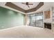 Living area with a fireplace, built-in shelving, and sliding doors to a balcony at 902 W Glendale Ave # 203, Phoenix, AZ 85021