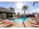 Community swimming pool with lounge chairs and palm trees at 902 W Glendale Ave # 203, Phoenix, AZ 85021