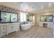 Spa-like bathroom with double vanities, soaking tub, and patterned tile at 910 E Canyon Way, Chandler, AZ 85249