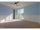 Light blue bedroom with sliding glass door and wainscoting at 910 E Canyon Way, Chandler, AZ 85249