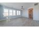 Bright bedroom featuring wood-look tile floors, ceiling fan, and access to bathroom at 910 E Canyon Way, Chandler, AZ 85249