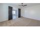 Bedroom with carpet flooring, ceiling fan and dark doors at 910 E Canyon Way, Chandler, AZ 85249