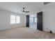 Bedroom with carpet, ceiling fan and access to another room at 910 E Canyon Way, Chandler, AZ 85249