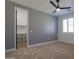 Bright bedroom with carpeted floor, ceiling fan, and walk-in closet at 910 E Canyon Way, Chandler, AZ 85249