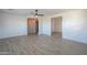 Well-lit bedroom with wood-look tile floors, offering access to other rooms at 910 E Canyon Way, Chandler, AZ 85249