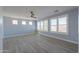 Spacious bedroom with light blue walls, wood-look tile floors, and plantation shutters at 910 E Canyon Way, Chandler, AZ 85249