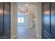 Elegant hallway with arched entryways and modern light fixture at 910 E Canyon Way, Chandler, AZ 85249