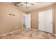 Simple bedroom with tile floors and double door closet at 9233 E Lobo Ave, Mesa, AZ 85209