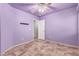 Purple bedroom with tile floors and a door to another room at 9233 E Lobo Ave, Mesa, AZ 85209