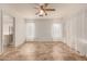 Bright bedroom with tile flooring, ceiling fan, and access to bathroom at 9233 E Lobo Ave, Mesa, AZ 85209