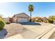 Light brown house with a two-car garage and gravel driveway at 9233 E Lobo Ave, Mesa, AZ 85209