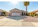 Single-story house with a two-car garage and desert landscaping at 9233 E Lobo Ave, Mesa, AZ 85209