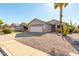 House with a two-car garage and desert landscaping at 9233 E Lobo Ave, Mesa, AZ 85209