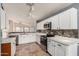 White kitchen with stainless steel appliances and pantry at 9233 E Lobo Ave, Mesa, AZ 85209