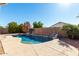 Inviting kidney shaped pool with surrounding landscaping at 9233 E Lobo Ave, Mesa, AZ 85209