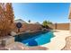 Inviting kidney shaped pool with surrounding landscaping at 9233 E Lobo Ave, Mesa, AZ 85209