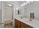 Bathroom with double sinks, wood cabinets, and bathtub at 9758 E Meseto Ave, Mesa, AZ 85209