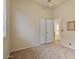 Simple bedroom with carpet, double doors, and window coverings at 9758 E Meseto Ave, Mesa, AZ 85209