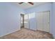 Bedroom with ceiling fan, carpet, and double door closet at 9758 E Meseto Ave, Mesa, AZ 85209