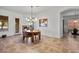 Spacious dining area with a round table and modern chandelier at 9758 E Meseto Ave, Mesa, AZ 85209