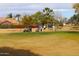 Golfers enjoying a sunny day on the course at 9758 E Meseto Ave, Mesa, AZ 85209