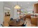 Kitchen features a breakfast nook, island, and wood cabinets at 9758 E Meseto Ave, Mesa, AZ 85209