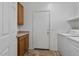 Laundry room with washer, dryer, cabinets and exterior access at 9758 E Meseto Ave, Mesa, AZ 85209